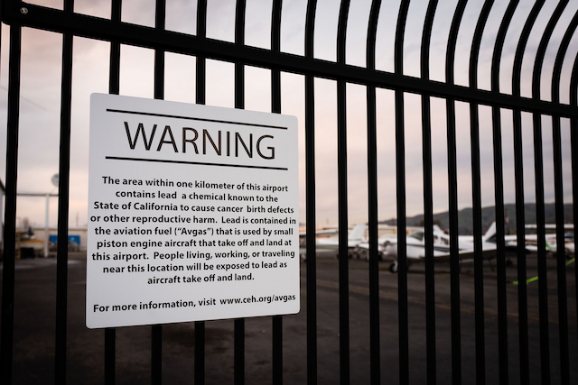 Warning about lead fuel on airport fence